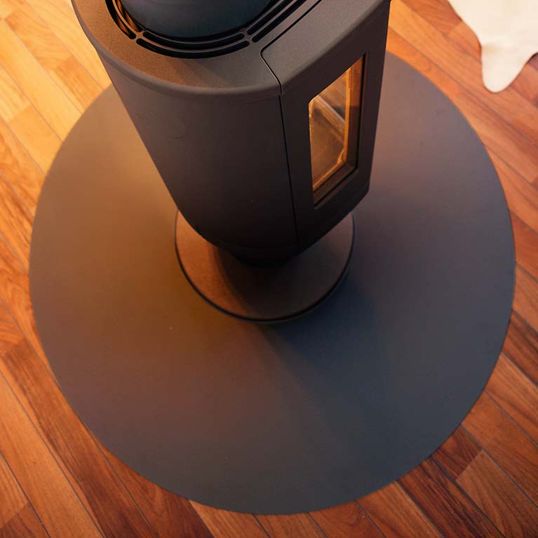Circular shaped floor protector for wood burning stoves