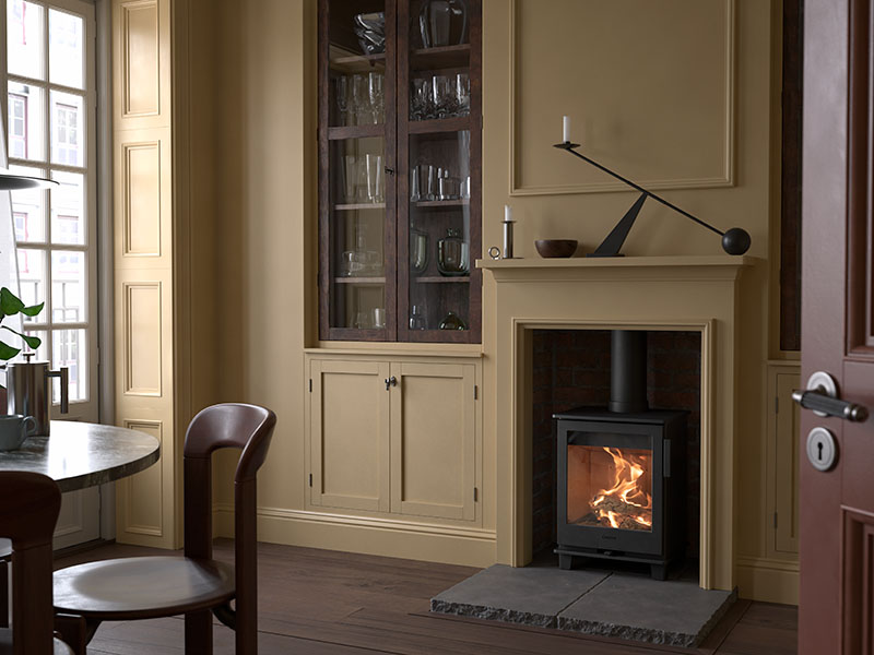 Contura 110 placed in a old fireplace inside a living room